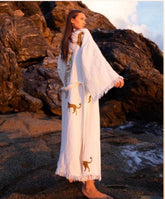 Woman in a white tiger robe with animal designs standing on rocky terrain.Turkish cotton kimono robe