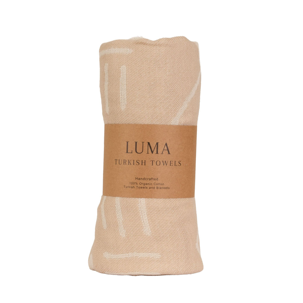 A lightweight Turkish towel with ethnic patterns.This super soft, sand-free towel and compact