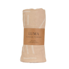 A lightweight Turkish towel with ethnic patterns.This super soft, sand-free towel and compact